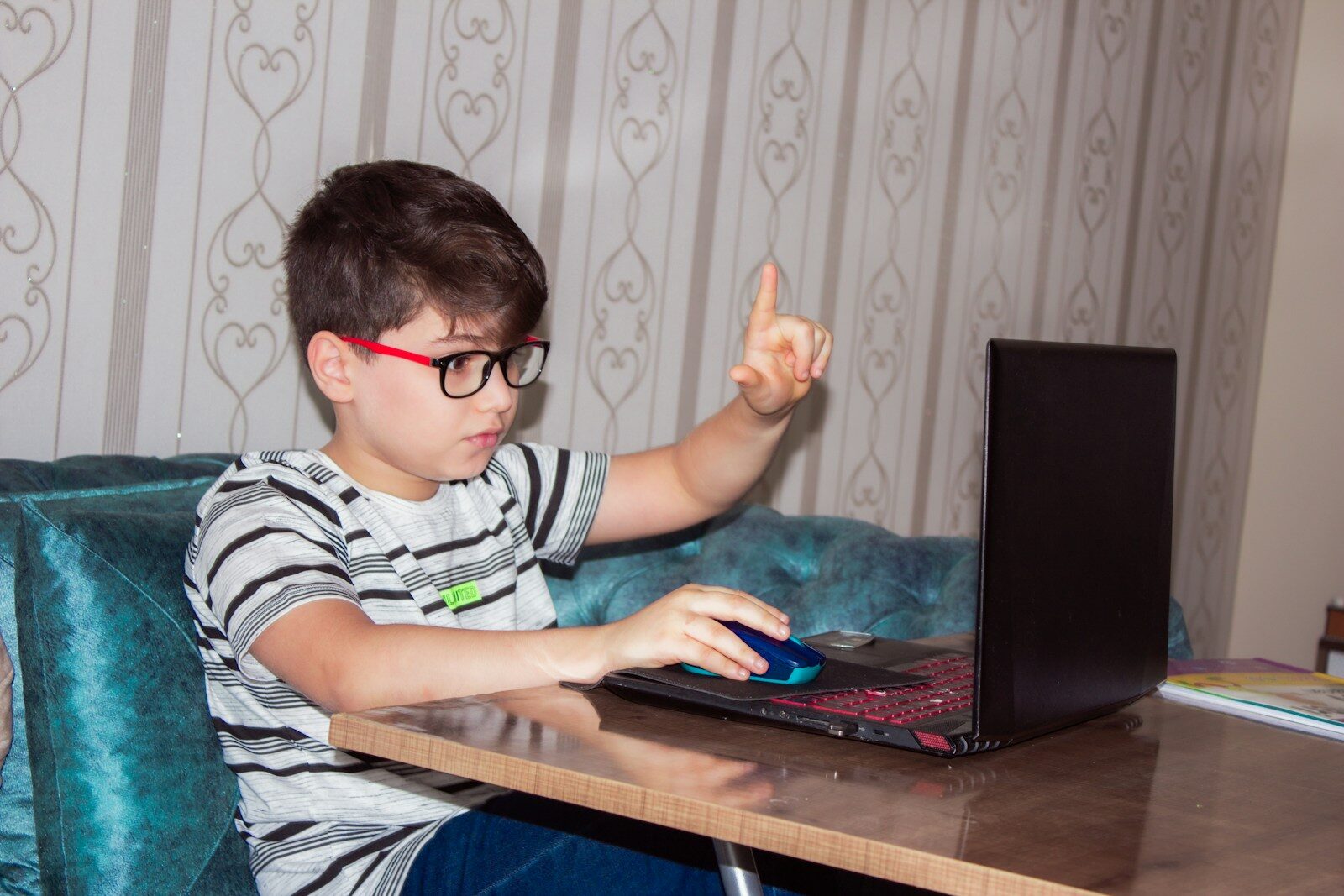 A child uses a laptop for a session with an online writing tutor service in San Diego, CA.